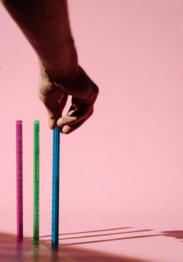 a hand trying to place pencils in an upright positions