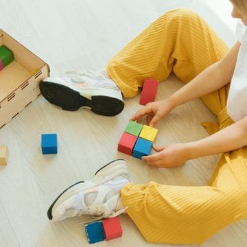 young child playing with colored blocks