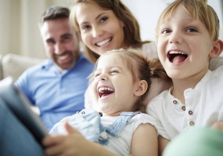 Children sitting together with parents and laughing