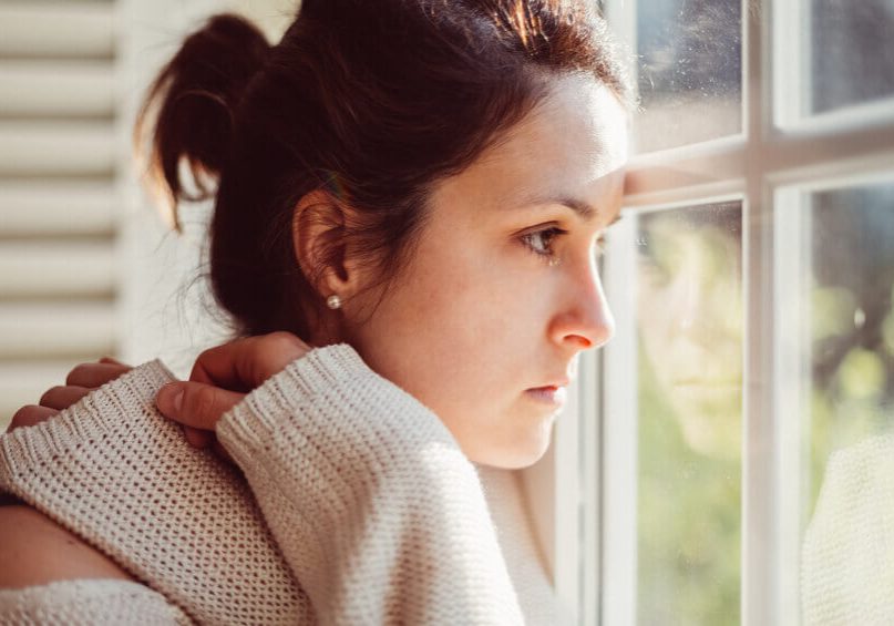 Thoughtful woman at home - copyspace