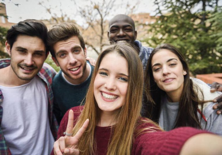 Multiracial group of friends taking selfie in a urban park